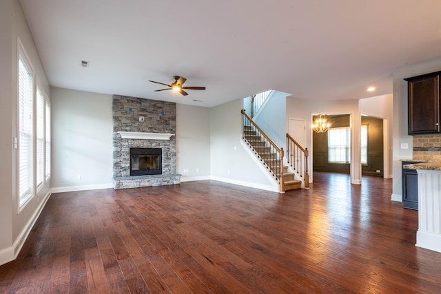 1805 Rachels Run, Lexington, KY 40509 - unfurnished living room featuring stairs, a chandelier, dark wood-style flooring, a ceiling fan, and a stone fireplace