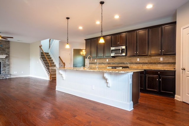 1805 Rachels Run, Lexington, KY 40509 - kitchen featuring stainless steel microwave, dark wood finished floors, decorative backsplash, a ceiling fan, and recessed lighting