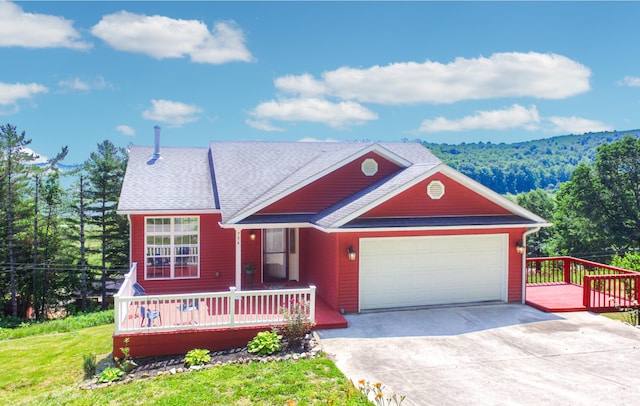 754 Countryside Cir, Mount Vernon, KY 40456 - view of front of house featuring a garage, driveway, a wooden deck, a front lawn, and a forest view