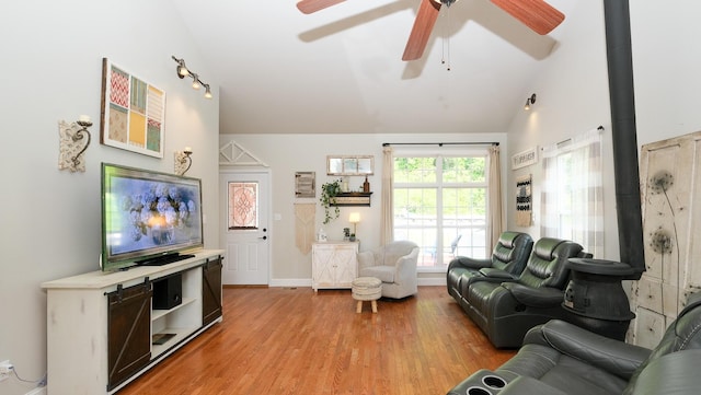 754 Countryside Cir, Mount Vernon, KY 40456 - living area featuring ceiling fan, light wood-style flooring, high vaulted ceiling, a wood stove, and baseboards