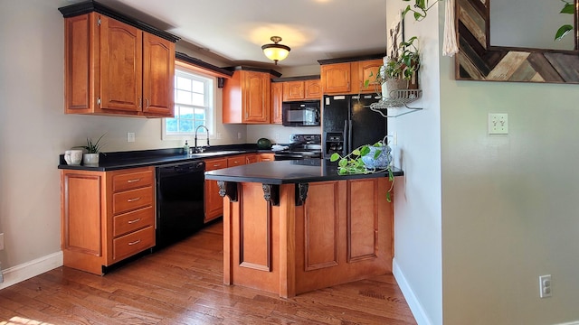 754 Countryside Cir, Mount Vernon, KY 40456 - kitchen featuring black appliances, dark countertops, baseboards, wood finished floors, and a sink