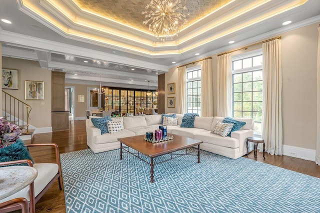 1617 Harmony Hall Ln, Lexington, KY 40502 - living room featuring a chandelier, a tray ceiling, ornamental molding, stairs, and wood finished floors