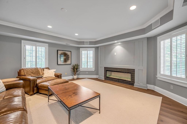 1617 Harmony Hall Ln, Lexington, KY 40502 - living room featuring ornamental molding, wood finished floors, a tile fireplace, a tray ceiling, and baseboards
