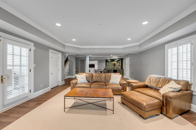 1617 Harmony Hall Ln, Lexington, KY 40502 - living area featuring a raised ceiling, stairway, wood finished floors, ornamental molding, and a bar