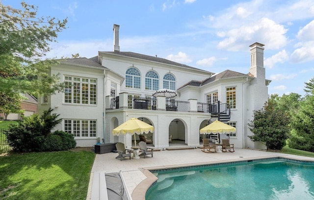 1617 Harmony Hall Ln, Lexington, KY 40502 - back of property with a balcony, a patio area, an outdoor pool, and a chimney