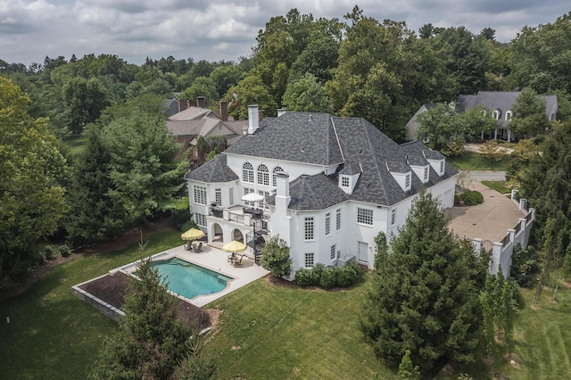 1617 Harmony Hall Ln, Lexington, KY 40502 - back of house featuring a balcony, a patio area, an outdoor pool, a chimney, and stucco siding