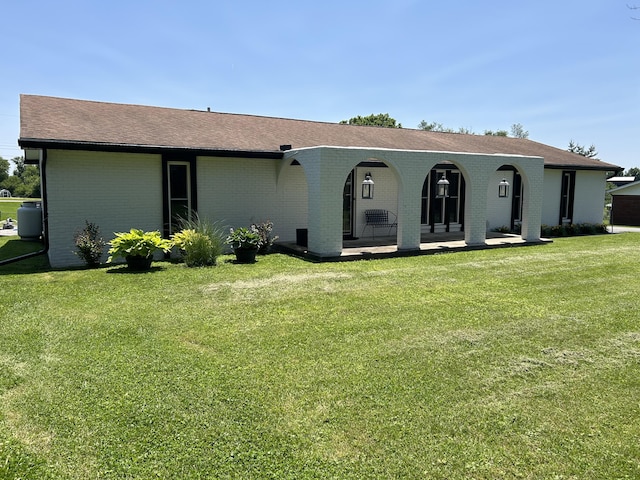 609 Clintonville Rd, Winchester, KY 40391 - view of front of house featuring brick siding, a front lawn, a porch, and roof with shingles