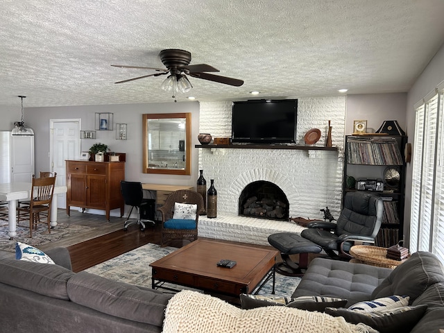 609 Clintonville Rd, Winchester, KY 40391 - living room with a textured ceiling, wood finished floors, ceiling fan, and a fireplace