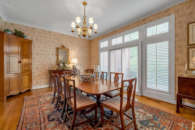 100 Idle Hour Dr Unit 8, Lexington, KY 40502 - dining area with light wood-style floors, a chandelier, wallpapered walls, crown molding, and baseboards