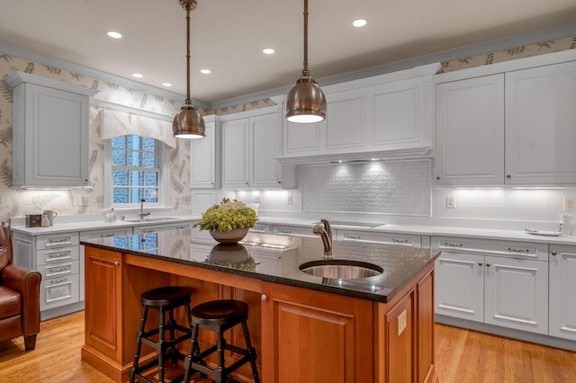 100 Idle Hour Dr Unit 8, Lexington, KY 40502 - kitchen featuring a sink, a center island with sink, light wood-type flooring, tasteful backsplash, and recessed lighting