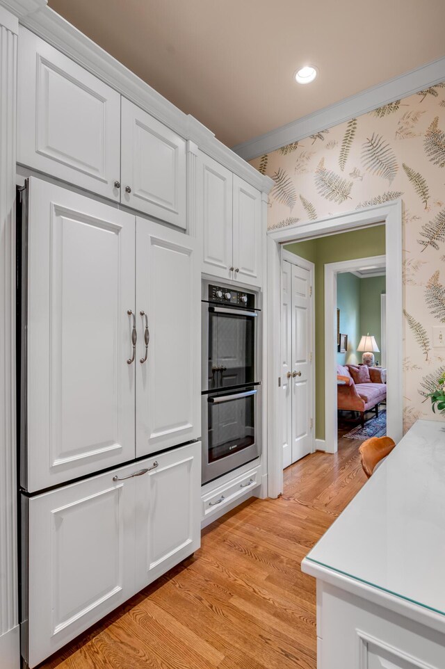 100 Idle Hour Dr Unit 8, Lexington, KY 40502 - kitchen featuring stainless steel double oven, white cabinets, light wood-style flooring, recessed lighting, and light countertops