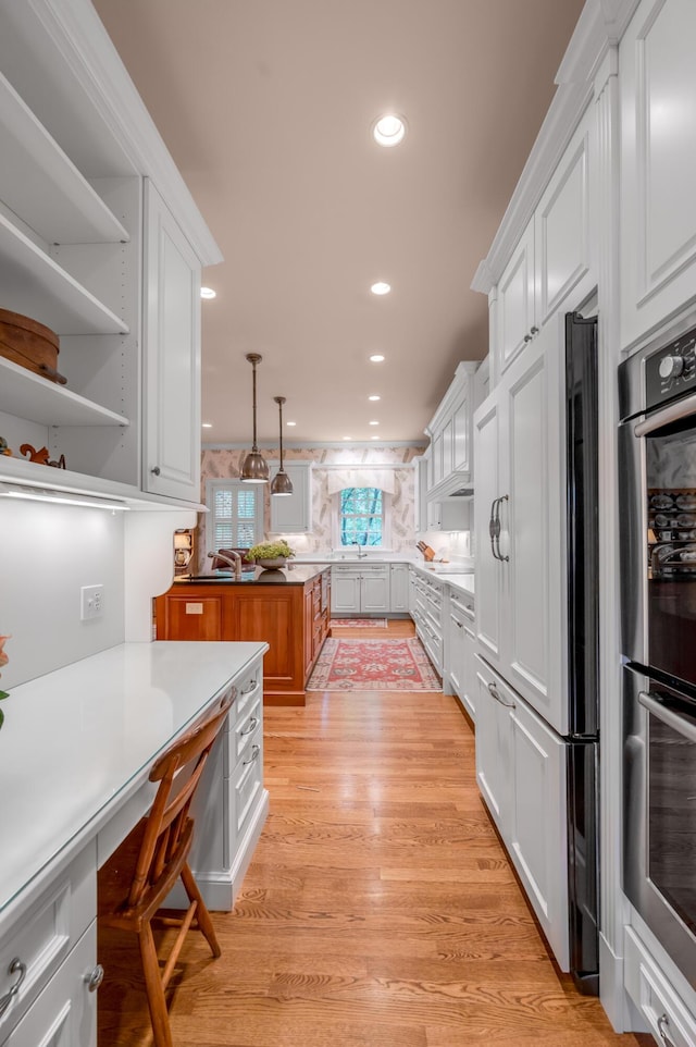 100 Idle Hour Dr Unit 8, Lexington, KY 40502 - kitchen featuring double oven, white cabinetry, light wood-style floors, and recessed lighting