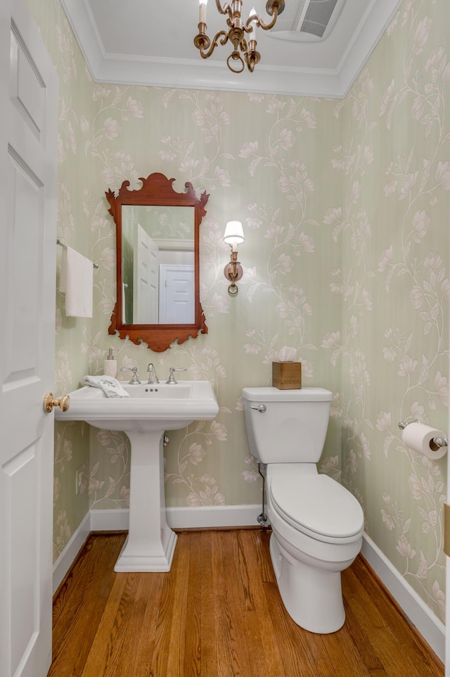 100 Idle Hour Dr Unit 8, Lexington, KY 40502 - half bathroom featuring wood finished floors, ornamental molding, a chandelier, toilet, and wallpapered walls