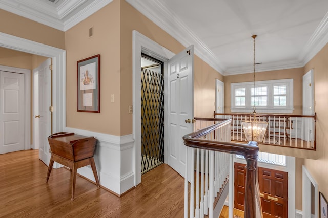 100 Idle Hour Dr Unit 8, Lexington, KY 40502 - hallway with a chandelier, an upstairs landing, wood finished floors, and crown molding