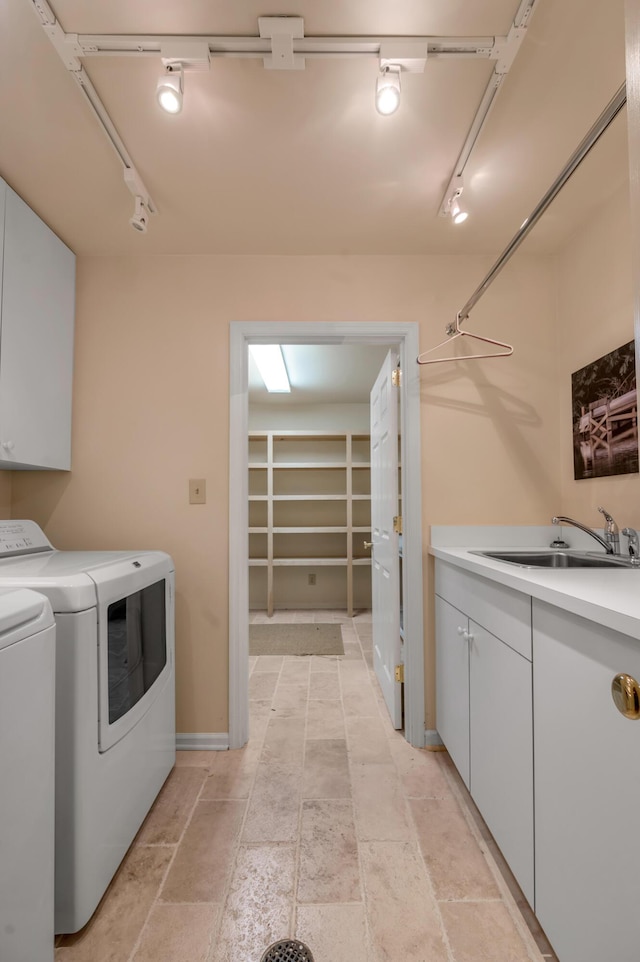 100 Idle Hour Dr Unit 8, Lexington, KY 40502 - washroom featuring washing machine and dryer, cabinet space, rail lighting, and stone tile flooring