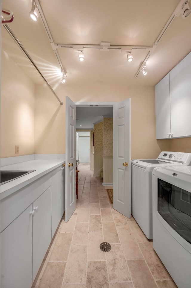 100 Idle Hour Dr Unit 8, Lexington, KY 40502 - washroom with washing machine and clothes dryer, rail lighting, cabinet space, and stone tile floors