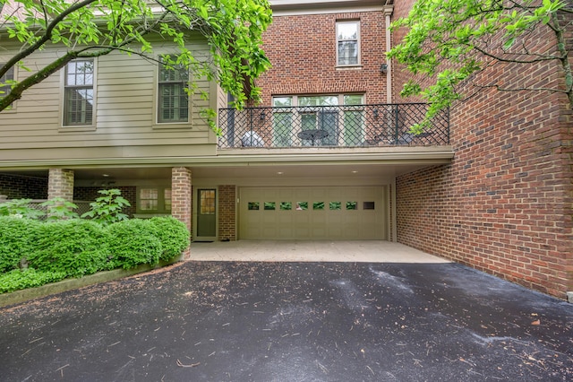 100 Idle Hour Dr Unit 8, Lexington, KY 40502 - view of front of property with a balcony, driveway, an attached garage, and brick siding