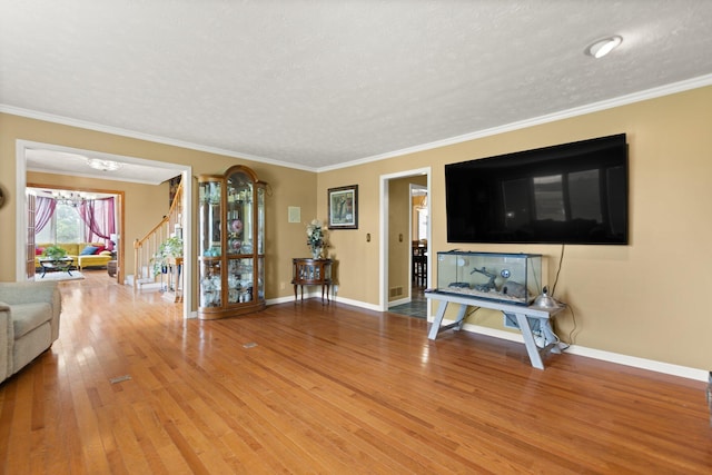 137 Indian Cave Subdivision, Monticello, KY 42633 - unfurnished living room featuring a chandelier, stairway, light wood-style flooring, a textured ceiling, and baseboards