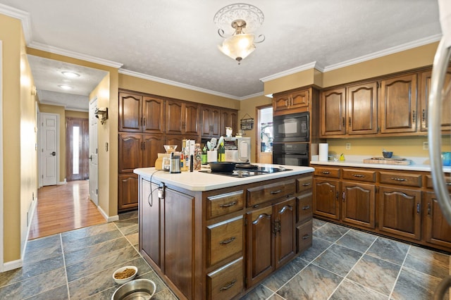 137 Indian Cave Subdivision, Monticello, KY 42633 - kitchen featuring black appliances, a center island, light countertops, stone tile floors, and baseboards