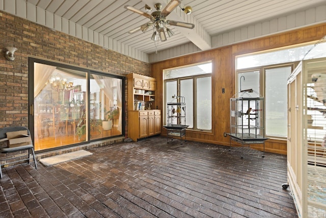 137 Indian Cave Subdivision, Monticello, KY 42633 - unfurnished sunroom with a ceiling fan, brick flooring, wooden walls, beamed ceiling, and brick wall