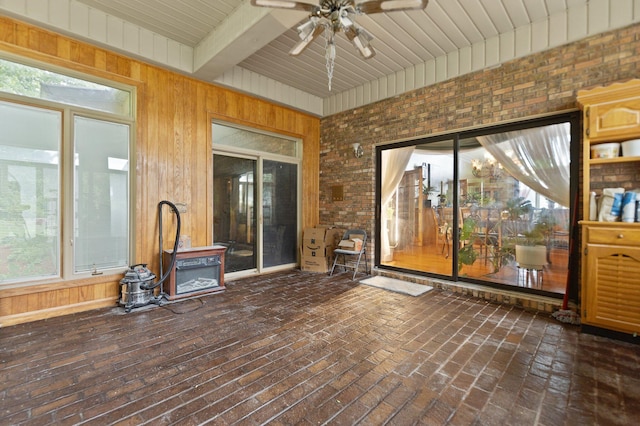 137 Indian Cave Subdivision, Monticello, KY 42633 - unfurnished sunroom with a ceiling fan, wood walls, brick flooring, wood ceiling with exposed beams, and brick wall