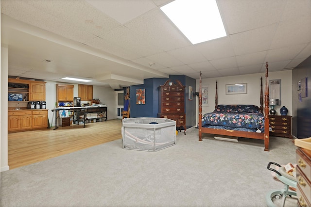 137 Indian Cave Subdivision, Monticello, KY 42633 - bedroom featuring light carpet, a drop ceiling, a sink, and light wood-style floors