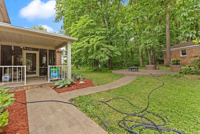 137 Indian Cave Subdivision, Monticello, KY 42633 - view of grassy yard with a sunroom and a patio area