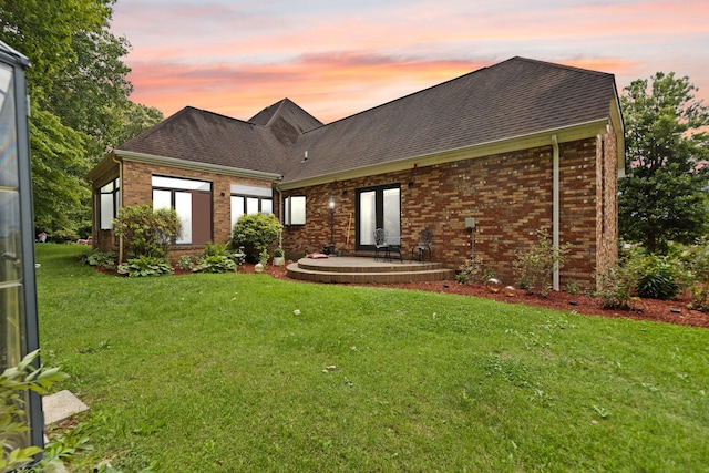 137 Indian Cave Subdivision, Monticello, KY 42633 - view of front of home featuring brick siding, a lawn, a shingled roof, and a patio area