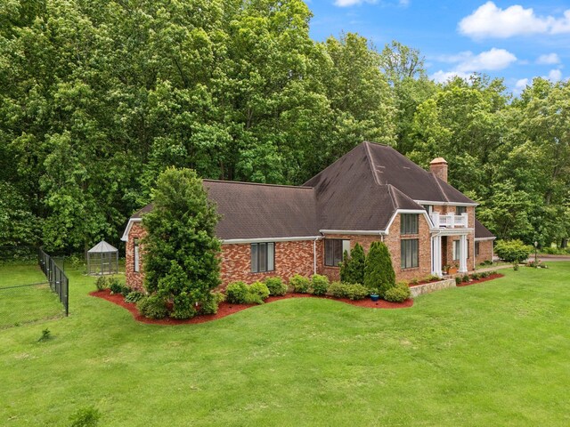 137 Indian Cave Subdivision, Monticello, KY 42633 - view of front of home with a chimney, brick siding, and roof with shingles