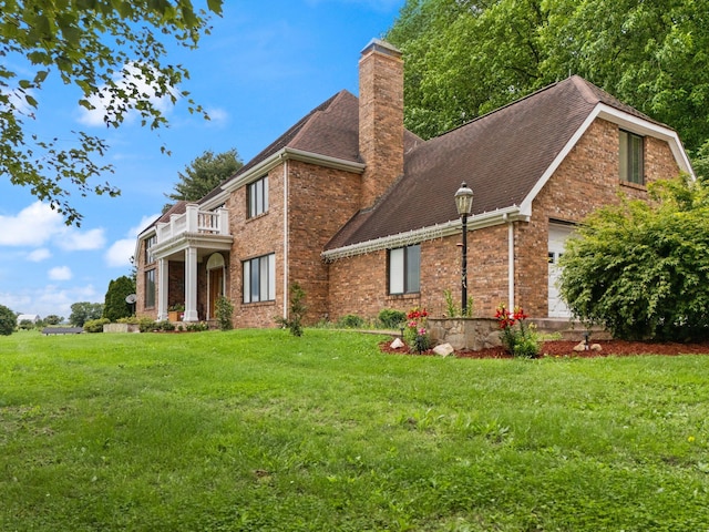 137 Indian Cave Subdivision, Monticello, KY 42633 - view of front of property with a balcony, a chimney, brick siding, and a front yard