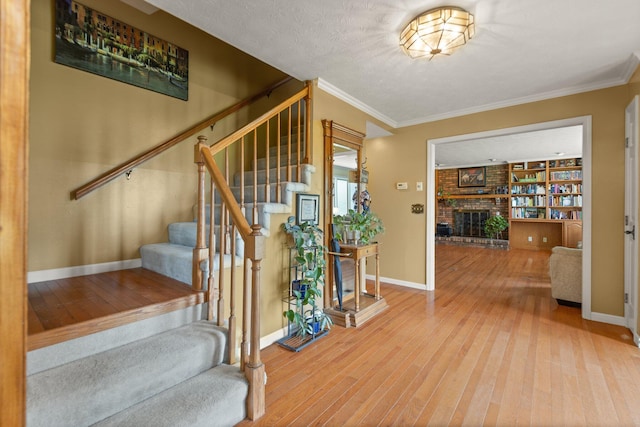 137 Indian Cave Subdivision, Monticello, KY 42633 - entryway with wood-type flooring, stairs, baseboards, crown molding, and a fireplace