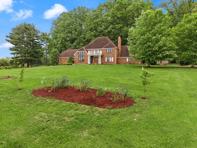 137 Indian Cave Subdivision, Monticello, KY 42633 - view of front of home featuring a front lawn, a chimney, and brick siding