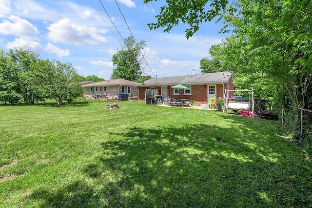 1976 Greenleaf Dr, Lexington, KY 40505 - back of house featuring a patio area, brick siding, and a lawn