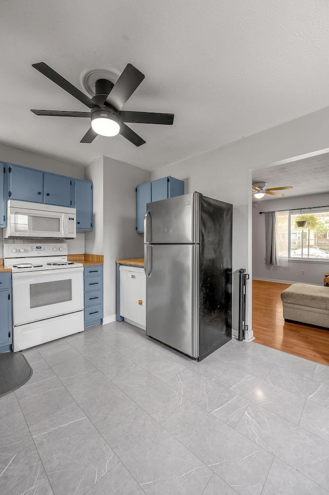 1976 Greenleaf Dr, Lexington, KY 40505 - kitchen with white appliances, blue cabinetry, a ceiling fan, and wood counters