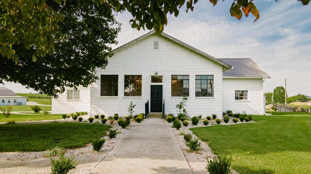 241 Old Glory Rd, Monticello, KY 42633 - modern farmhouse style home featuring entry steps, a front lawn, and metal roof