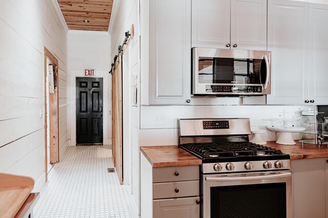 241 Old Glory Rd, Monticello, KY 42633 - kitchen with appliances with stainless steel finishes, wood counters, white cabinets, and wood walls