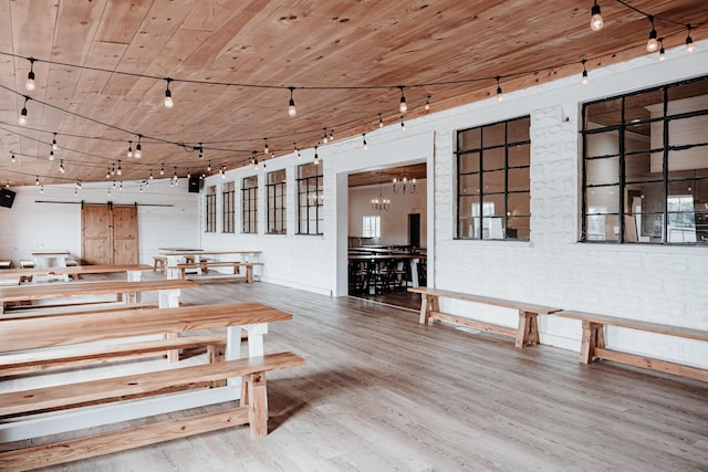 241 Old Glory Rd, Monticello, KY 42633 - dining area with wood finished floors, rail lighting, a chandelier, wooden ceiling, and a barn door