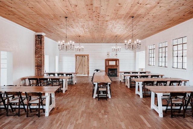241 Old Glory Rd, Monticello, KY 42633 - dining space with a chandelier, wood finished floors, ornamental molding, wooden ceiling, and a fireplace