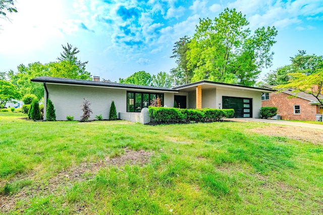 2933 Montavesta Rd, Lexington, KY 40502 - mid-century inspired home with an attached garage, driveway, brick siding, a front yard, and a chimney