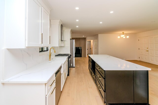 2933 Montavesta Rd, Lexington, KY 40502 - kitchen featuring white cabinets, appliances with stainless steel finishes, light wood-style floors, a center island, and recessed lighting