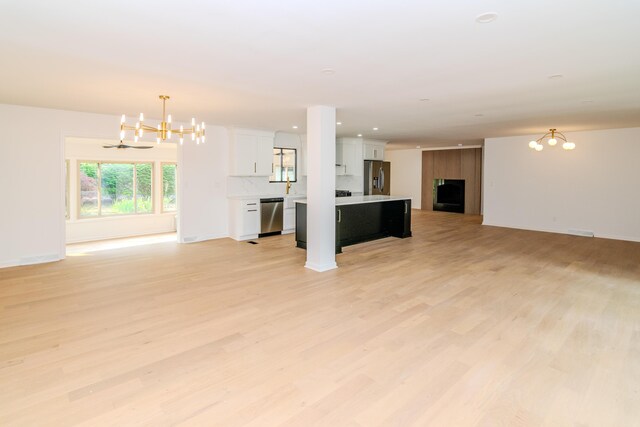 2933 Montavesta Rd, Lexington, KY 40502 - unfurnished living room featuring a chandelier, light wood finished floors, a sink, baseboards, and recessed lighting