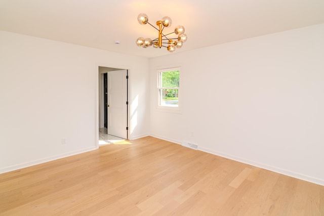2933 Montavesta Rd, Lexington, KY 40502 - spare room with a chandelier, light wood-style flooring, and baseboards