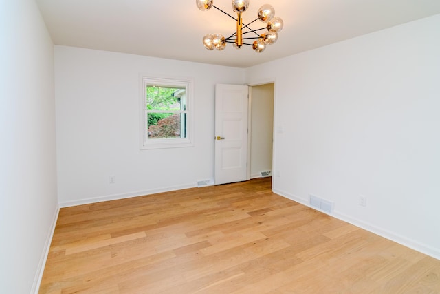 2933 Montavesta Rd, Lexington, KY 40502 - empty room featuring a chandelier, light wood-style floors, and baseboards