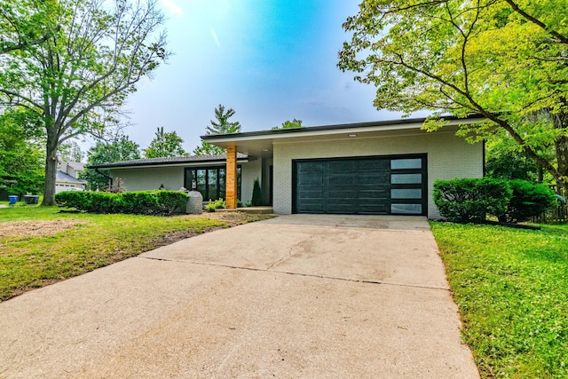 2933 Montavesta Rd, Lexington, KY 40502 - mid-century inspired home featuring brick siding, an attached garage, concrete driveway, and a front yard