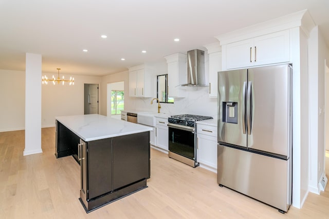 2933 Montavesta Rd, Lexington, KY 40502 - kitchen featuring appliances with stainless steel finishes, wall chimney range hood, a kitchen island, white cabinetry, and a chandelier