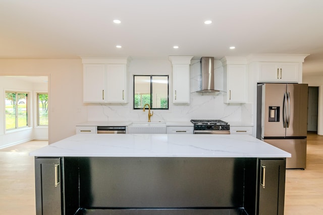2933 Montavesta Rd, Lexington, KY 40502 - kitchen featuring wall chimney range hood, stainless steel appliances, a sink, light wood-style flooring, and a center island