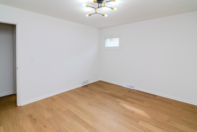 2933 Montavesta Rd, Lexington, KY 40502 - unfurnished room with a chandelier, light wood-style flooring, and baseboards