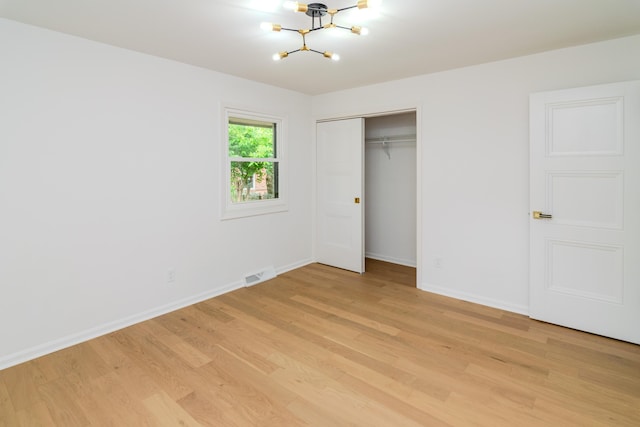2933 Montavesta Rd, Lexington, KY 40502 - unfurnished bedroom with a chandelier, light wood-style flooring, baseboards, and a closet