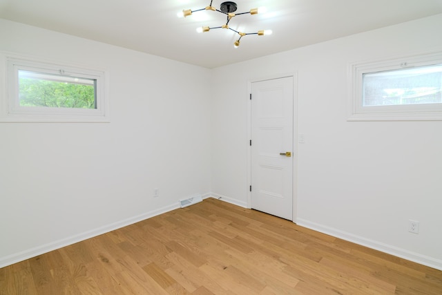 2933 Montavesta Rd, Lexington, KY 40502 - empty room with light wood-type flooring, a chandelier, and baseboards
