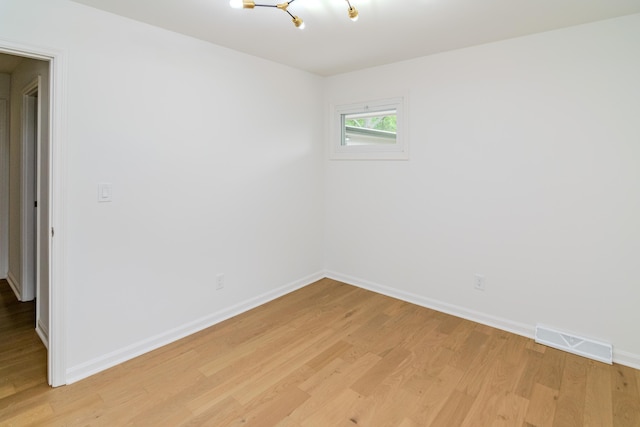 2933 Montavesta Rd, Lexington, KY 40502 - spare room with light wood-style flooring, a chandelier, and baseboards